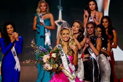 Miss Oklahoma Olivia Jordan is crowned Miss USA by Miss USA 2014 Nia Sanchez during the 2015 Miss USA pageant in Baton Rouge, La., Sunday, July 12, 2015. (AP Photo/Derick E. Hingle)